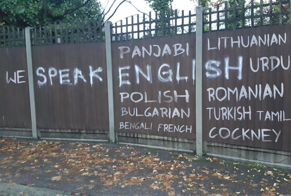 Modified graffiti image, 'we speak english' and several other languages